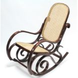 A bentwood-frame rocking chair inset woven-cane panel to the seat & back.