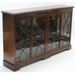 A 19th century-style mahogany bookcase with carved gadrooned edge, with five adjustable shelves