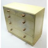 A mid-20th century pale yellow painted mahogany chest fitted two short & three long graduated