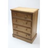 A pine upright chest fitted four long drawers with turned knob handles, & on plinth base, 28¾”