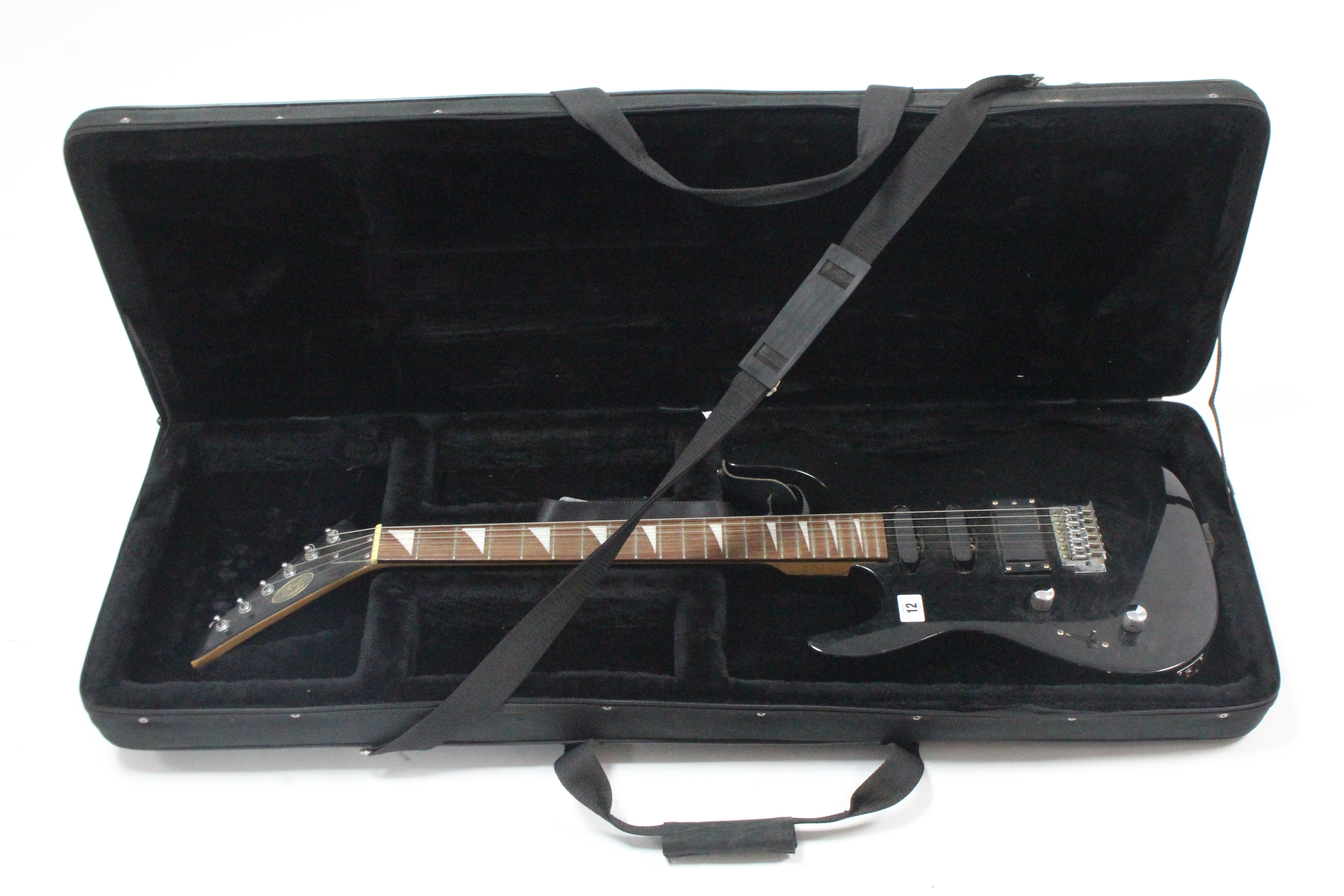 A Stagg (black) six-string electric guitar, with case.