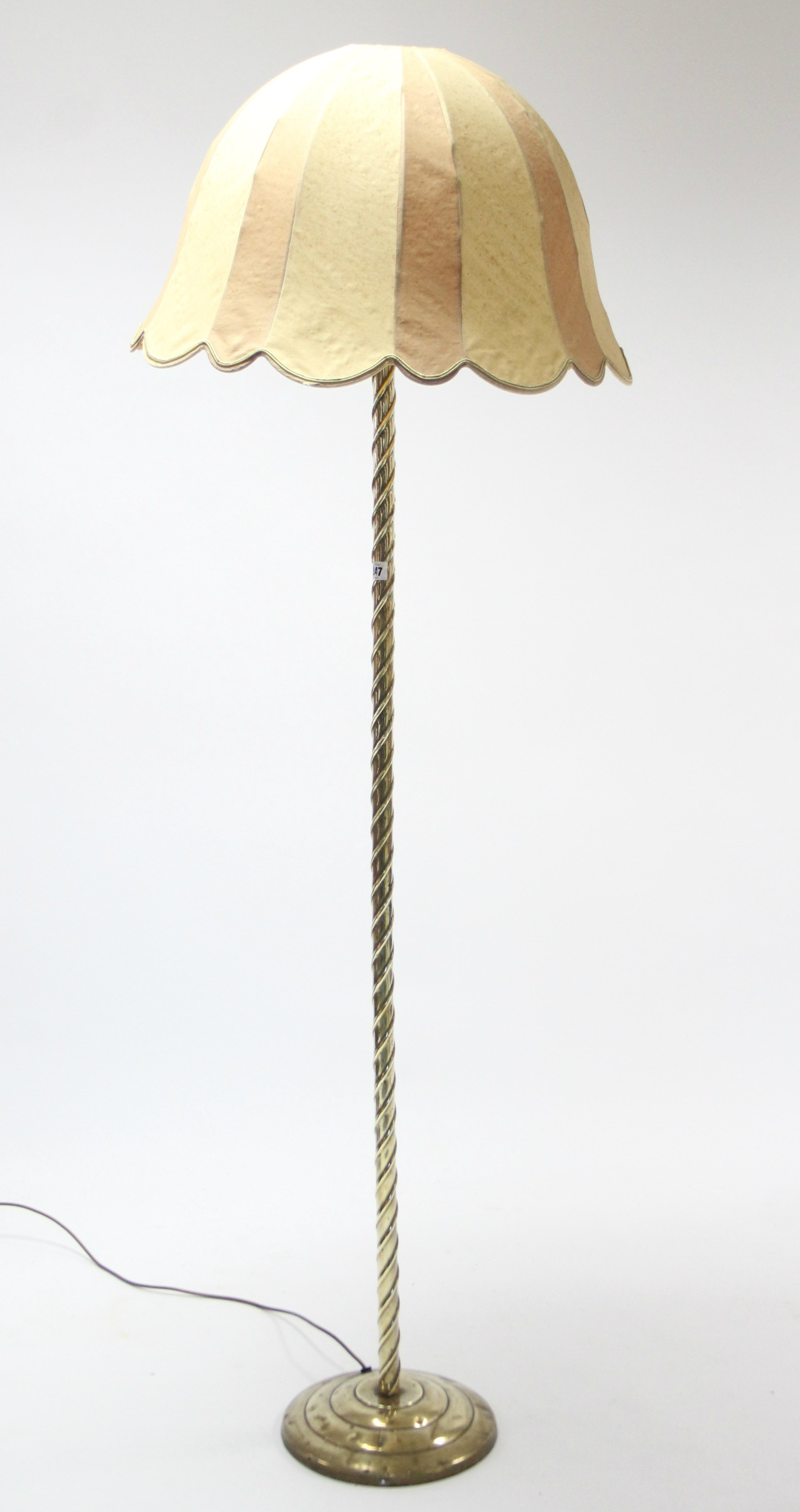 A brass standard lamp with spiral-twist centre column & on circular stepped base, with shade.