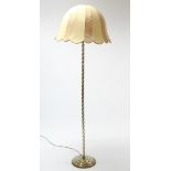 A brass standard lamp with spiral-twist centre column & on circular stepped base, with shade.
