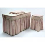 A pine inverted break-front knee-hole dressing table fitted with an arrangement of eight drawers,