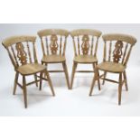 A set of four pine splat-back kitchen chairs with hard seats, & on ring-turned tapered legs with