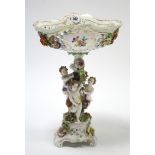 A Dresden floral decorated & floral encrusted tall comport with cherub figures to the centre column,
