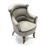 A late Victorian tub-shaped chair upholstered grey material, & on short turned tapered legs with