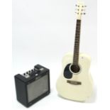A Rikter six-string acoustic guitar; & a Fender “G-Dec Junior” amplifier.