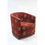 A tub-shaped chair upholstered crimson geometrical material.