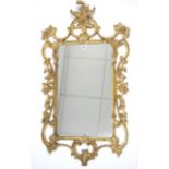 An 18th century-style gilt frame rectangular wall mirror with pierced scroll border, 41” x 22½”.