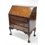 A 1930’s mahogany bureau with fitted interior enclosed by fall-front above three long graduated