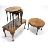 A 1930’s walnut low coffee table with carved gadrooned edge to the circular top, & on four slender