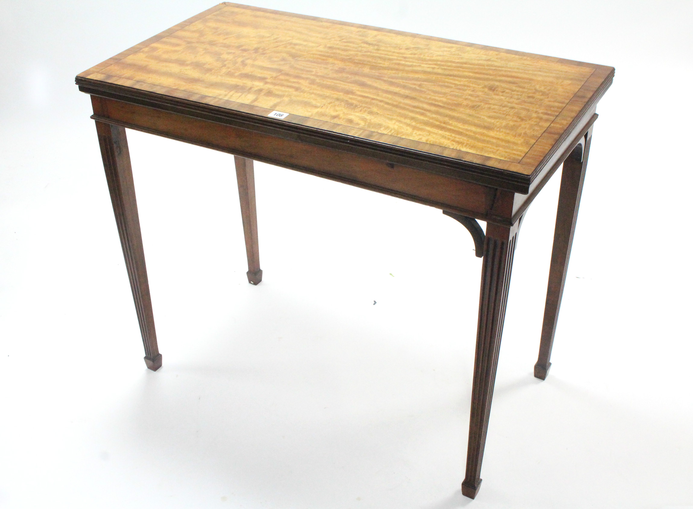 A 19th century figured mahogany card table inset green baize to the rectangular fold-over top, & on