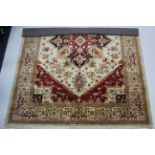 An eastern style small carpet of crimson & cream ground with geometric design to centre within