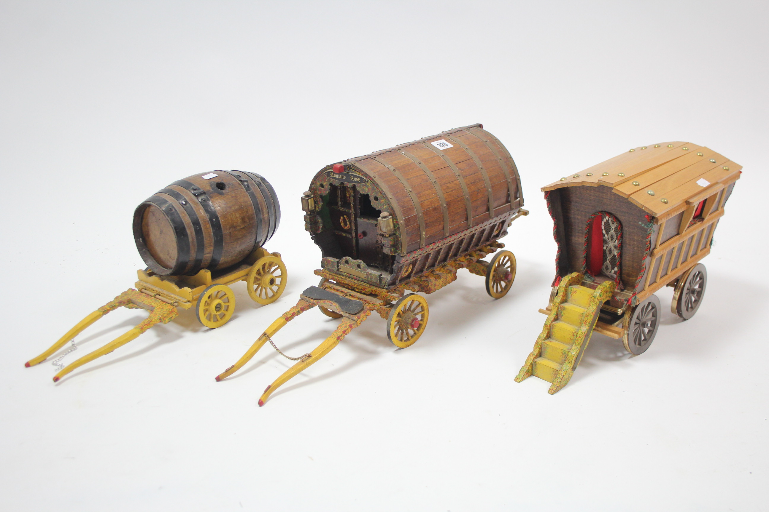 Three large wooden model carts (various sizes).