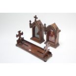 A late 19th century mahogany adjustable book trough with crucifix-style shaped end supports;