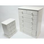 A white-finish chest fitted two short & four long graduated drawers with turned knob handles, & on