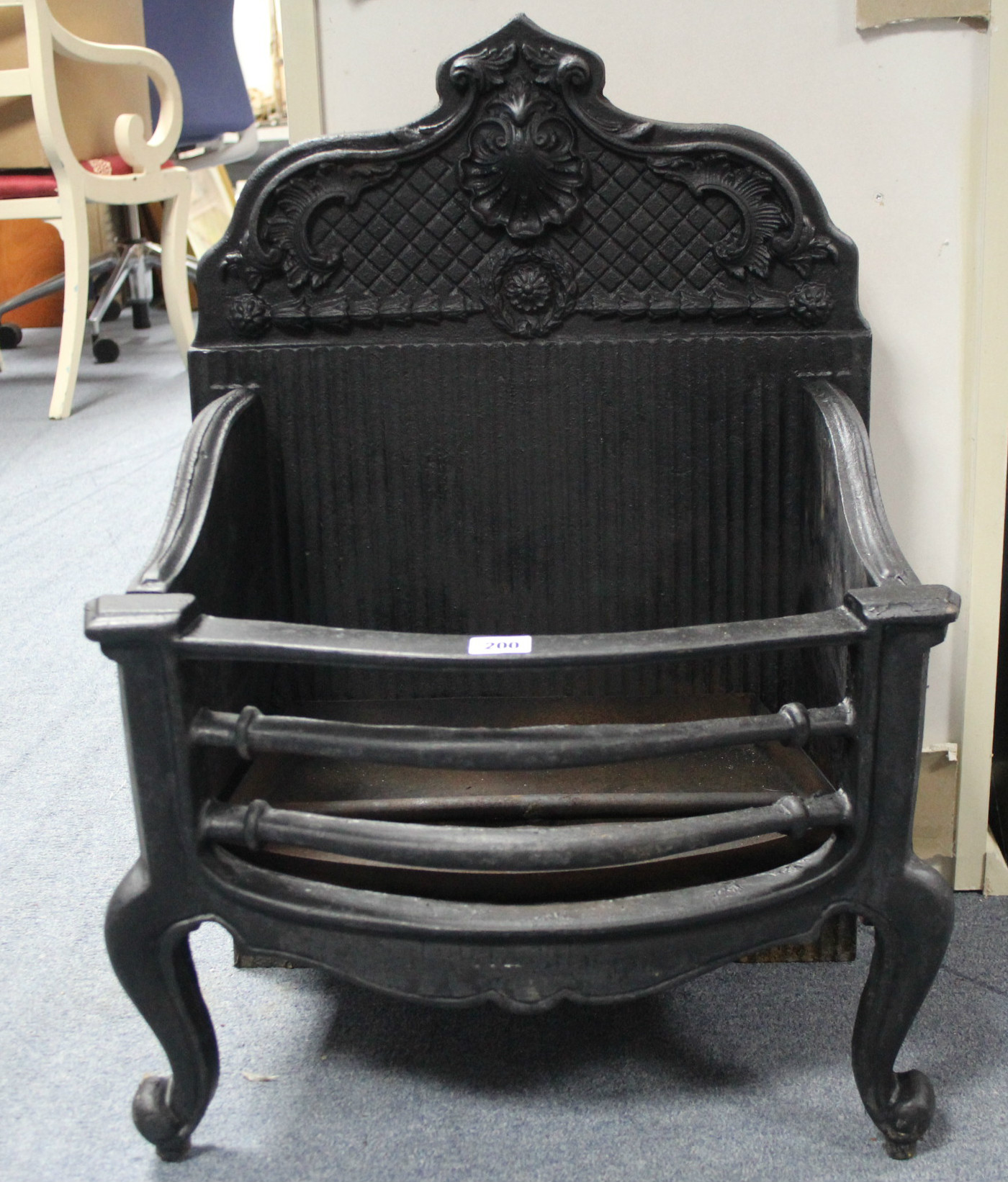 A 19th century-style black painted cast-iron fire grate, 19” wide x 26” high.