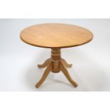 A walnut-finish circular drop-leaf kitchen table on turned centre column & four cabriole legs, 40”