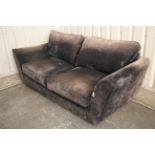 A modern three-seater settee with loose cushions to the seat & back, upholstered mauve velour, 81”