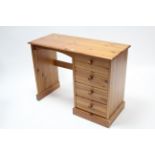 A pine kneehole dressing table fitted four long drawers to the right-hand side, 39¼” wide.