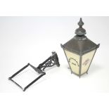 A copper frame “Britannia Inn” lantern of square tapered form, 27” high, with wall bracket.