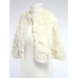 A White fur silk-lined ladies cape, bears label “Madame Briggs, Richmond S.W.”; a 1970’s poncho;