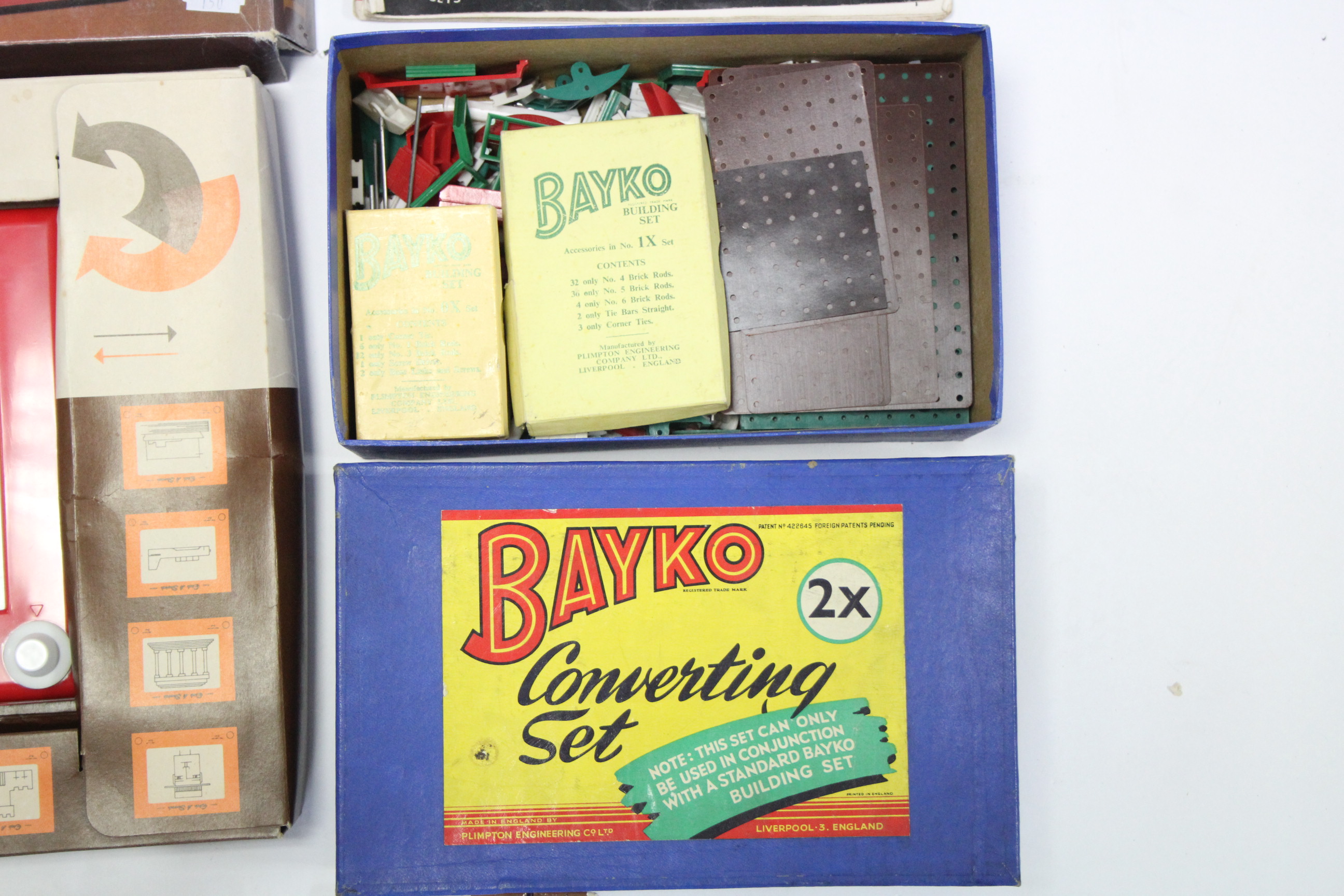 A Bayko “2X” converting set, boxed; a Bayko instructions booklet; various items of loose Bayko;