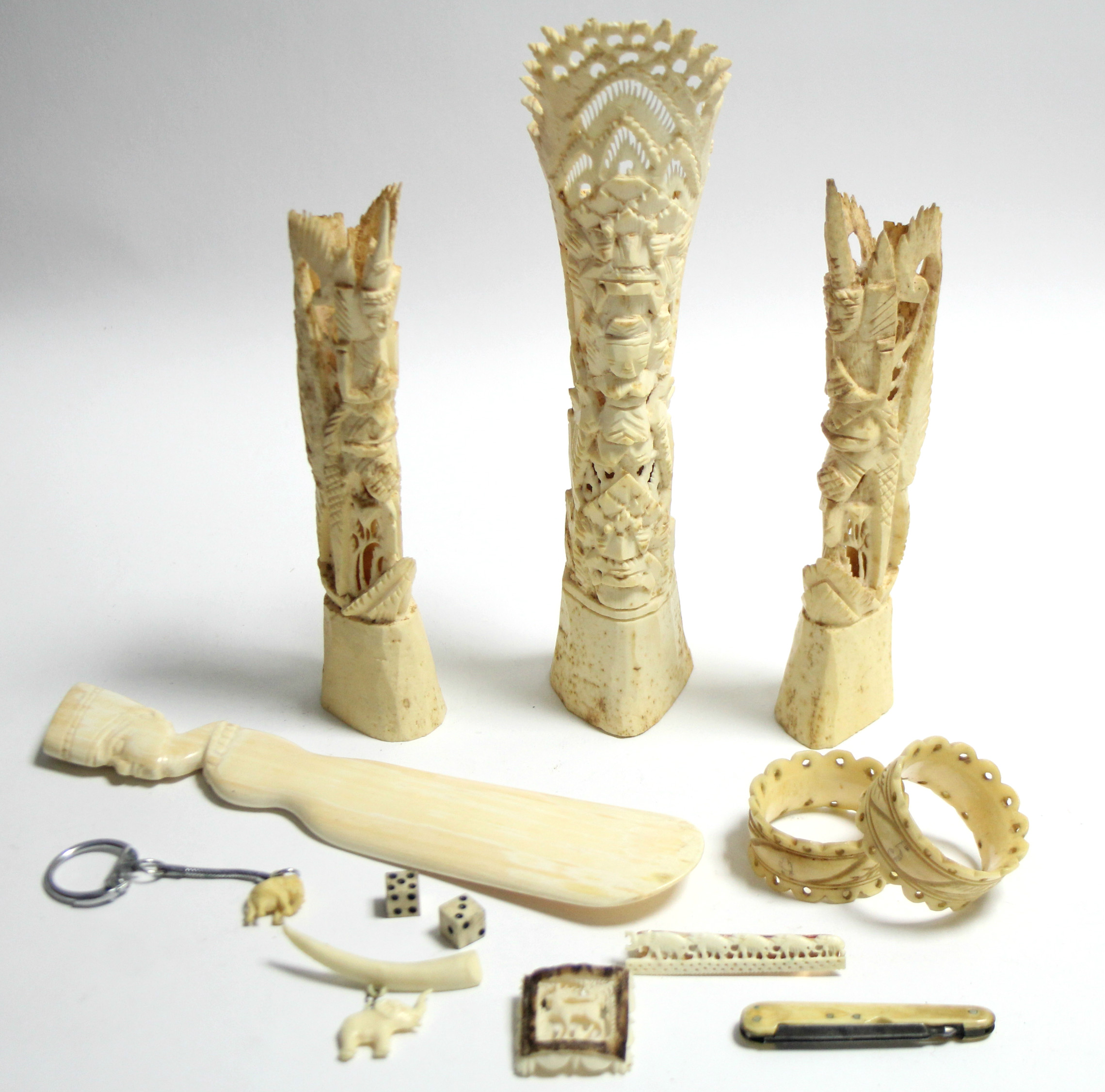 An ivory shoehorn with bust handle; a pair of carved ivory napkin rings; three ivory brooches; &