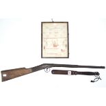 A treen truncheon with turned grip, 14½” long; a Milbro rifle; & a small needlework sampler, 10” x