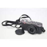 A LEICA “x1” Digital Camera; four Canon camera lenses; & various other camera accessories.