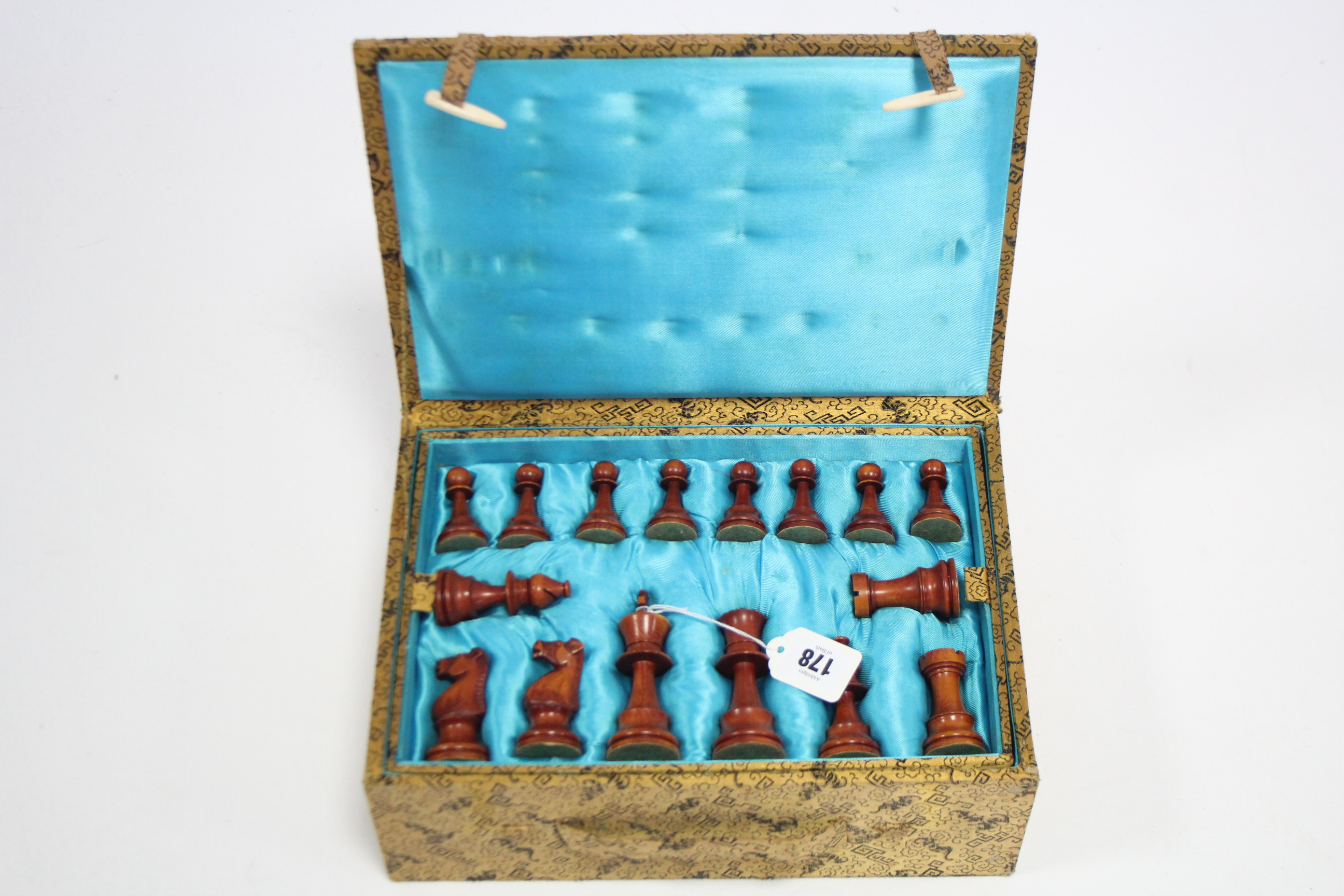 A Chinese carved ivory chess set (size of Kings 4” high), in fitted case.