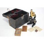 AN ERNST LEITZ WETZLAR BLACK LACQUERED MONOCULAR MICROSCOPE WITH BRASS FITTINGS (No. 27373 6),