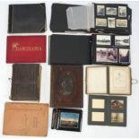 A 1930’s carved walnut-bound family photograph album containing various family photographs; together