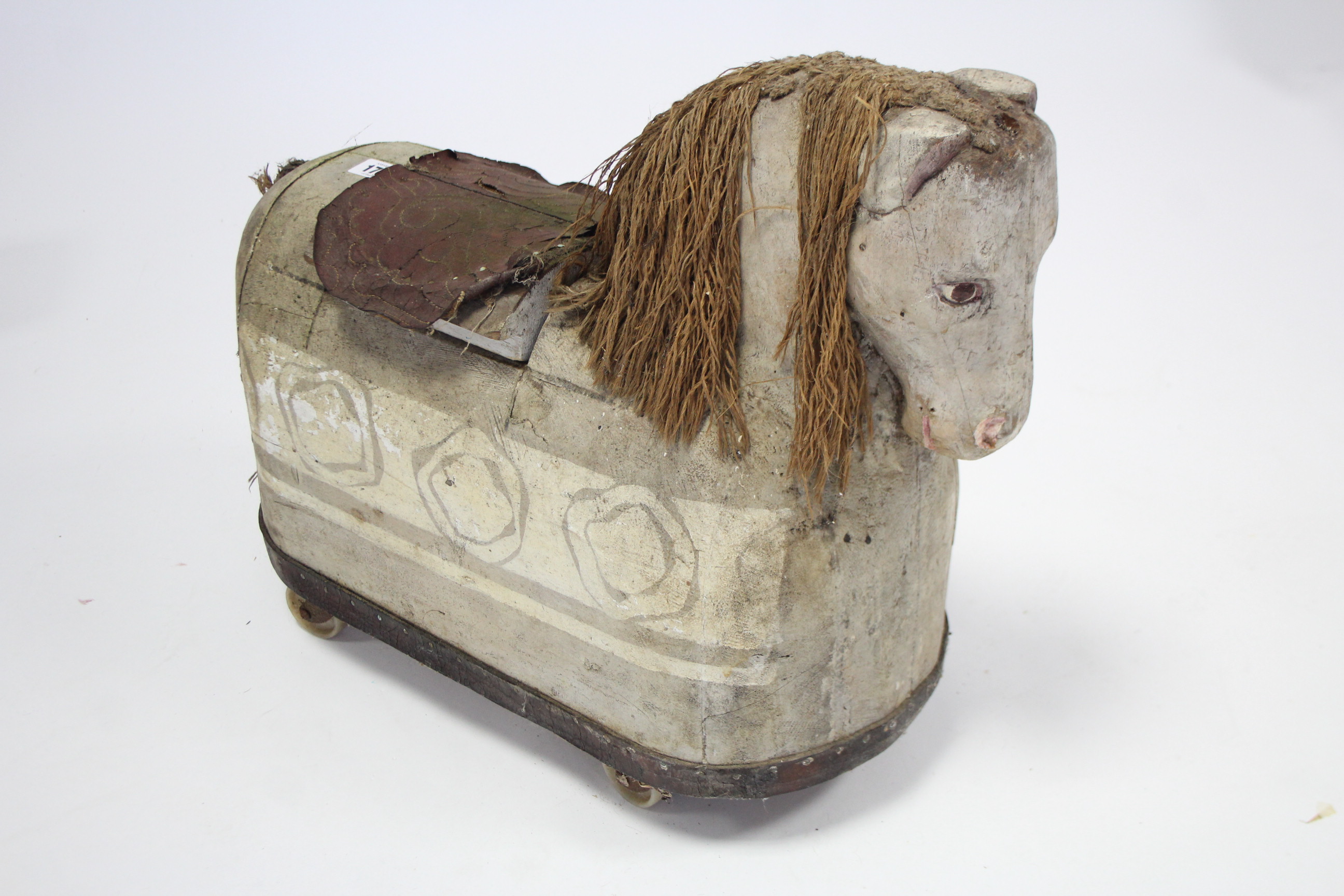 A Scandinavian-style painted & carved wood child’s ride-on-horse, 22” long x 18” high.