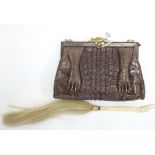 A Crocodile skin handbag with gilt-metal clasp; & a fly whisk with carved ivory handle.