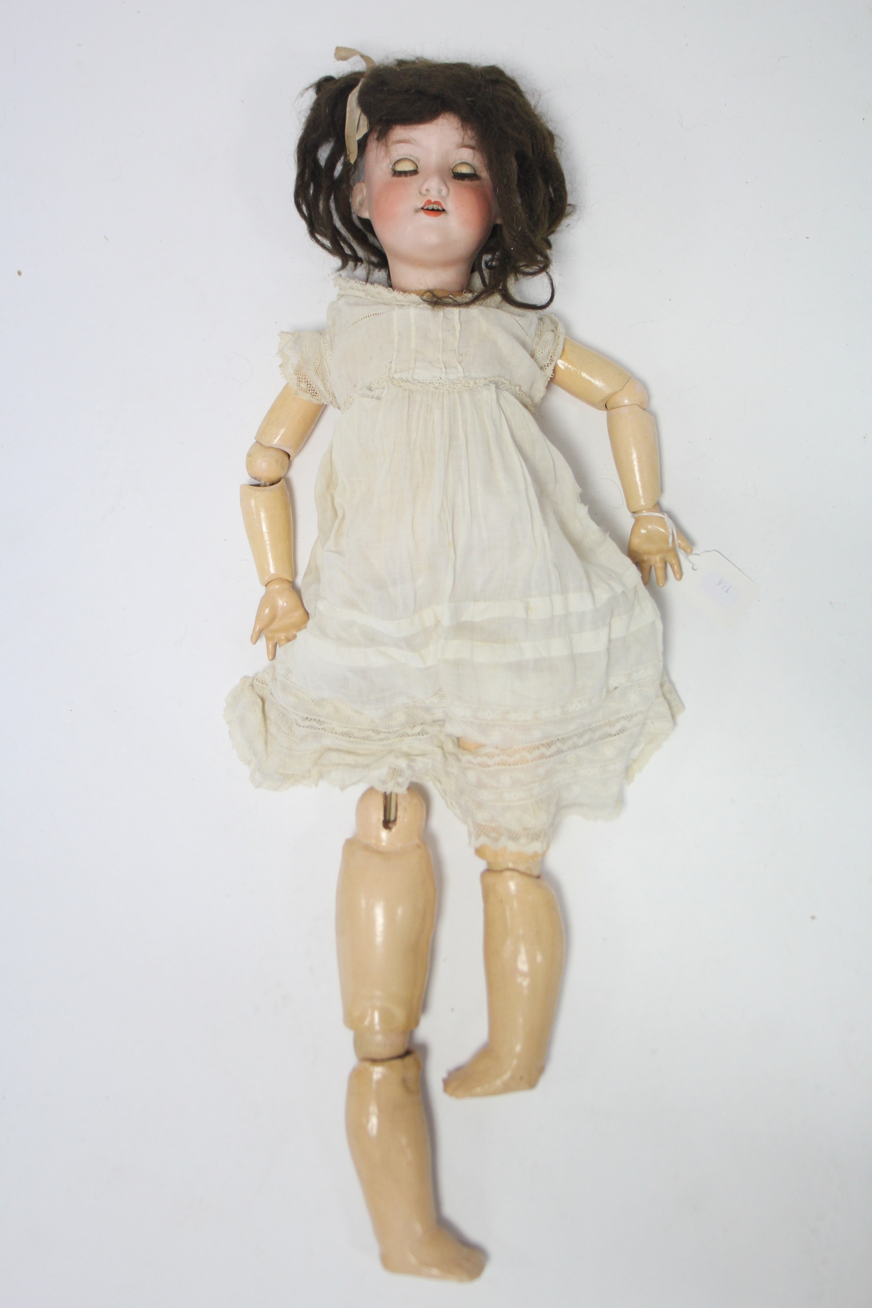 An Armand Marseilles bisque head girl doll (Germany 390.A. 6. M.) with brown sleeping eyes, open