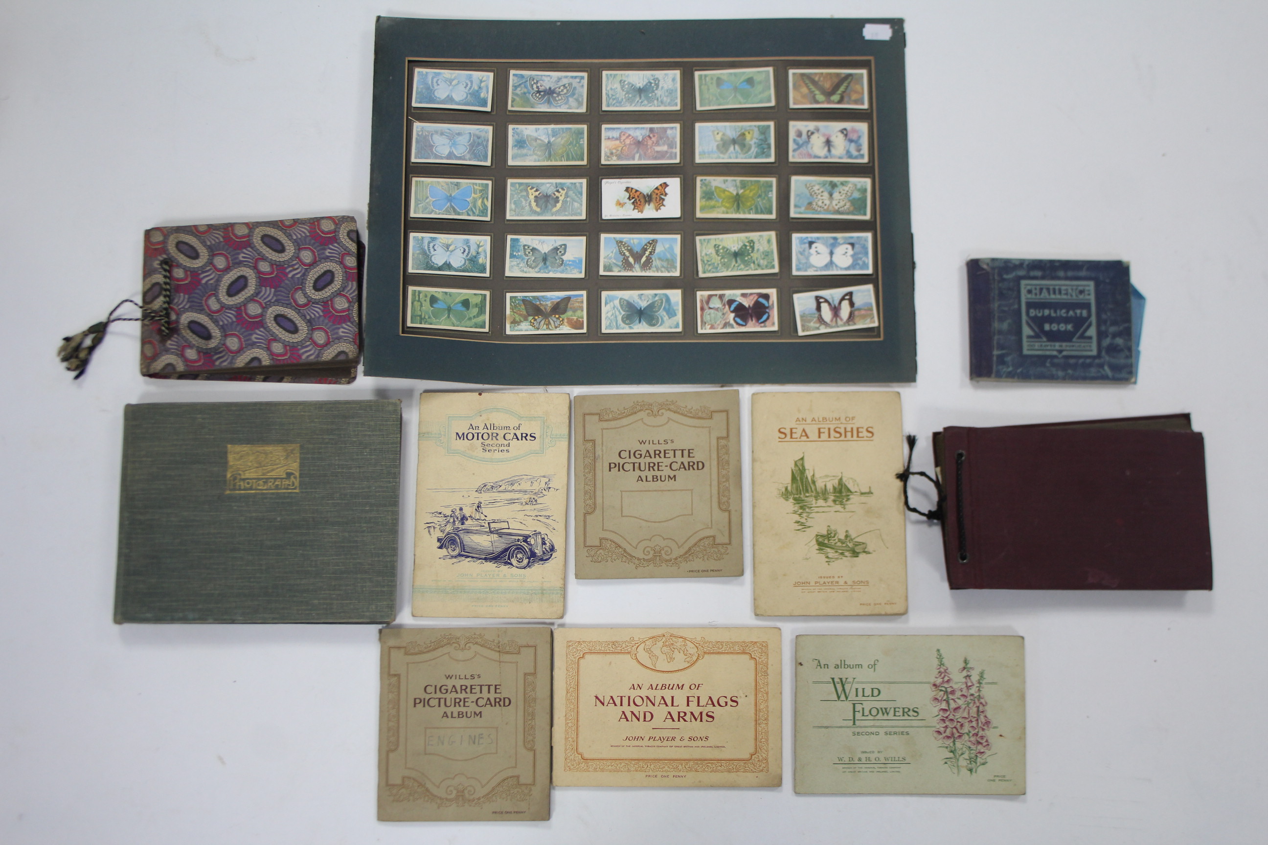 A collection of assorted cigarette cards contained in nine albums & loose.