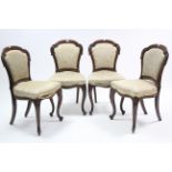 A set of four Victorian carved rosewood dining chairs, the padded balloon-backs & seats