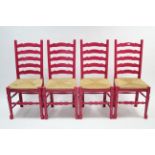 A set of four painted oak ladder-back dining chairs with woven-rush seats, & on turned legs & pad