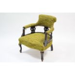 An Edwardian tub-shaped chair upholstered pale green material, & on short cabriole legs; & a child’