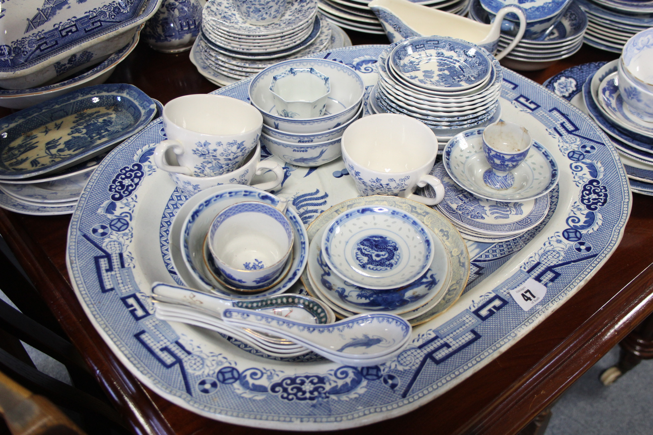 A Staffordshire pottery blue & white “Willow” pattern vegetable tureen; a similar meat plate; &