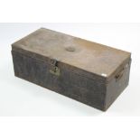 A late 19th/early 20th century japanned metal travelling trunk with hinged lift-lid, & wrought-