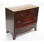 An early 19th century mahogany chest of two short & two long drawers with brass oval handles, on