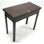 A 19th century mahogany tea table with rectangular fold-over top & on square chamfered legs, 32”