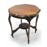 An early 20th century mahogany circular two-tier occasional table on cabriole legs with diagonal