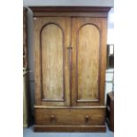 A Victorian mahogany wardrobe with moulded cornice, enclosed by pair of panel doors above a long