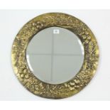 A brass embossed frame circular wall mirror inset bevelled plate, 18¾” diameter; together with