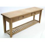 A pine low side table with rectangular top, fitted two frieze drawers & on square tapered legs