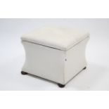 A square box ottoman with hinged lift-lid, concave sides & on bun feet, 19¾” wide.